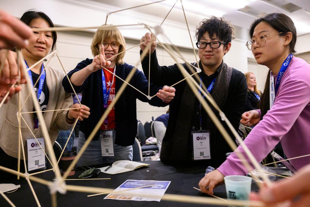 Four attendees participate in a hands-on activity